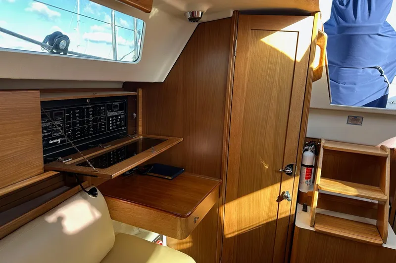  Yacht Photos Pics Interior of 2015 Catalina 315 sailboat with wooden cabinetry and navigation panel.