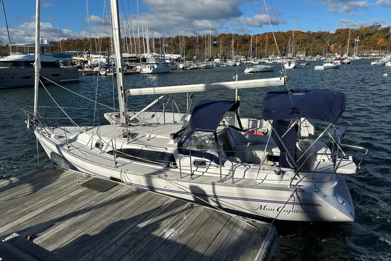  Yacht Photos Pics 2015 Catalina 315 sailboat docked in a marina, surrounded by other boats.