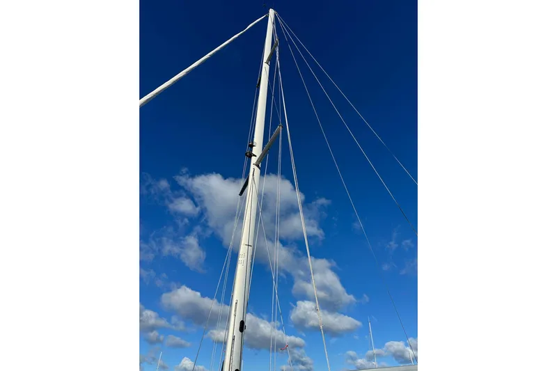  Yacht Photos Pics Mast of 2015 Catalina 315 sailboat against a clear blue sky with clouds.