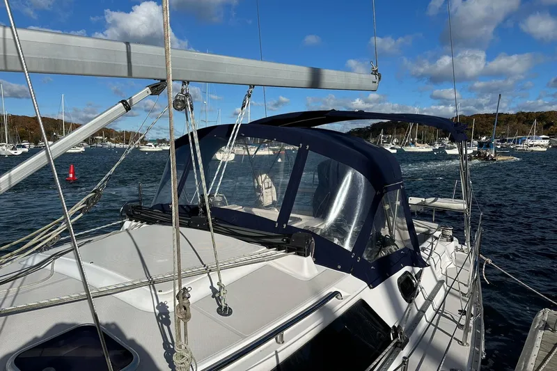  Yacht Photos Pics 2015 Catalina 315 sailboat docked in a marina, surrounded by other boats under a blue sky.