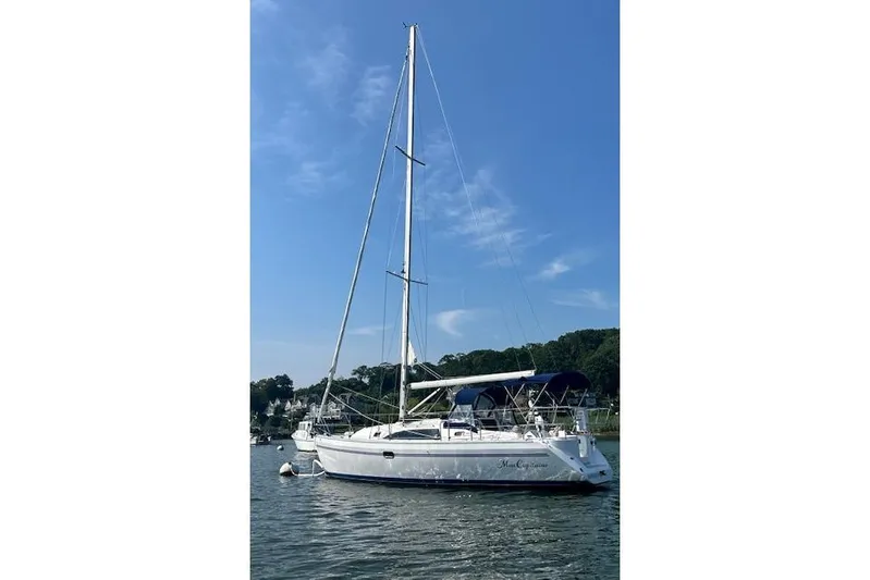  Yacht Photos Pics 2015 Catalina 315 sailboat anchored on calm water under a clear blue sky.