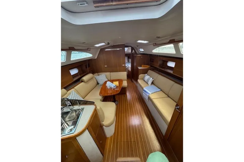  Yacht Photos Pics Interior of 2015 Catalina 315 sailboat with cozy seating and wooden finishes.