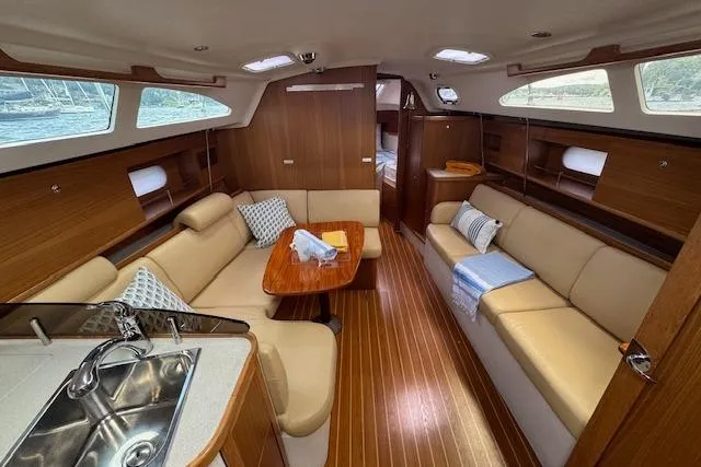  Yacht Photos Pics Interior of 2015 Catalina 315 sailboat with cozy seating and wooden finishes.