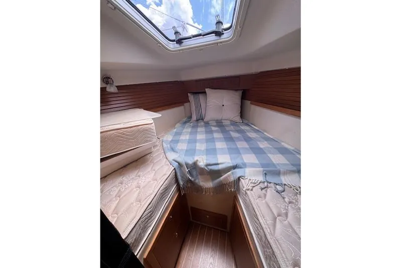 Yacht Photos Pics Cozy cabin interior of 2015 Catalina 315 sailboat with bed and skylight.