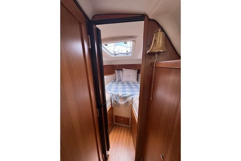  Yacht Photos Pics Interior cabin of 2015 Catalina 315 sailboat with cozy bed and wooden finish.