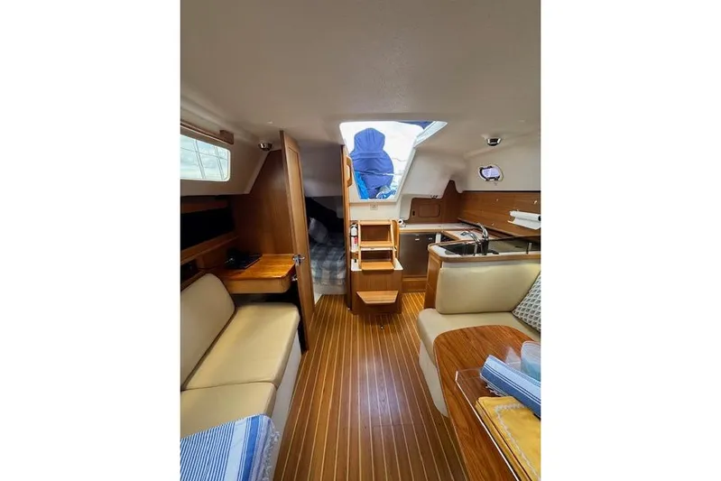  Yacht Photos Pics Interior of a 2015 Catalina 315 sailboat with wood finish and cozy seating.