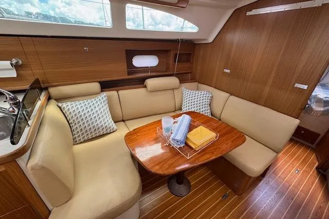  Yacht Photos Pics 2015 Catalina 315 yacht interior with cozy seating and wooden table.