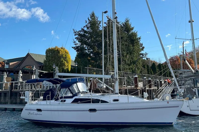  Yacht Photos Pics 2015 Catalina 315 sailboat docked at marina, clear blue sky, trees in background.