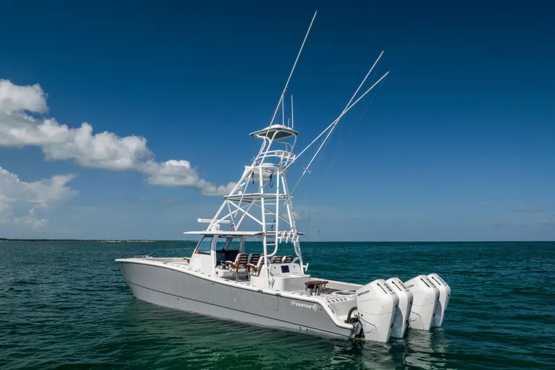  Yacht Photos Pics 2024 Freeman 43 boat with multiple outboard engines on open water.