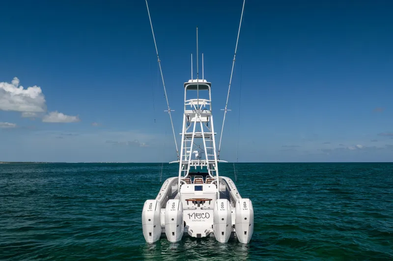  Yacht Photos Pics 2024 Freeman 43 boat with multiple engines on open water under clear blue sky.