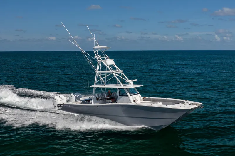  Yacht Photos Pics 2024 Freeman 43 boat cruising on open ocean under clear blue sky.