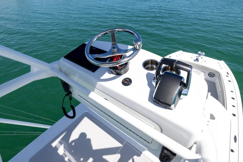  Yacht Photos Pics 2024 Freeman 43 boat helm with steering wheel and throttle controls on open water.