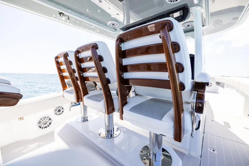  Yacht Photos Pics Luxury seating on 2024 Freeman 43 boat, featuring elegant wood and white upholstery.