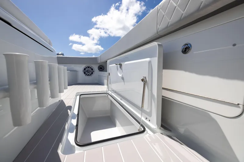  Yacht Photos Pics 2024 Freeman 43 boat deck with open storage compartment under clear blue sky.