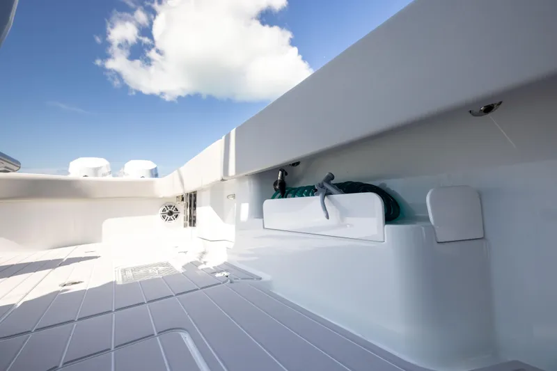  Yacht Photos Pics 2024 Freeman 43 boat deck with storage compartment under a clear blue sky.