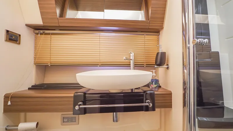 Brigadone Yacht Photos Pics Luxurious bathroom interior of 2016 Azimut 55S yacht with modern sink and wooden accents.