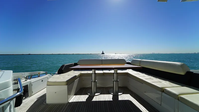 Brigadone Yacht Photos Pics 2016 Azimut 55S yacht deck with seating, overlooking serene ocean and clear blue sky.