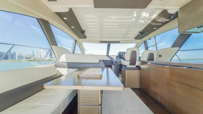Brigadone Yacht Photos Pics Luxurious interior of 2016 Azimut 55S yacht with modern seating and panoramic windows.
