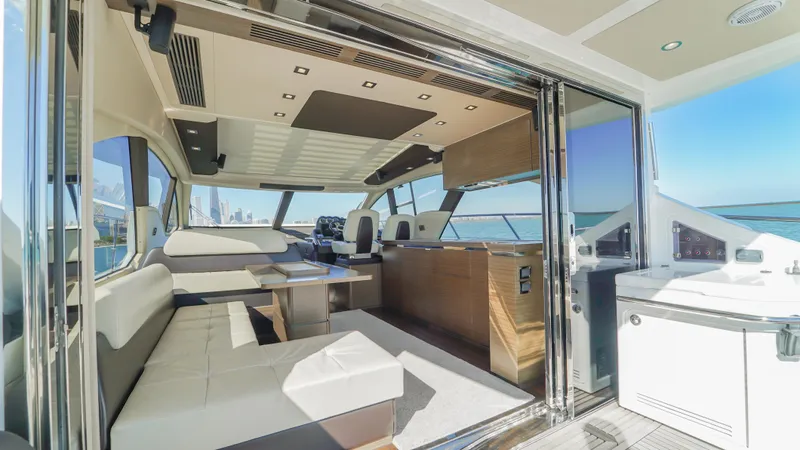 Brigadone Yacht Photos Pics Luxurious interior of a 2016 Azimut 55S yacht with modern seating and panoramic views.
