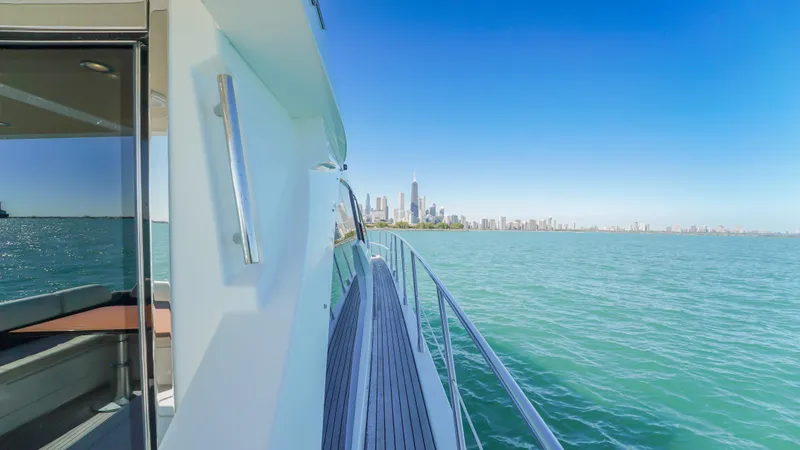 Brigadone Yacht Photos Pics 2016 Azimut 55S yacht cruising with city skyline in the background.