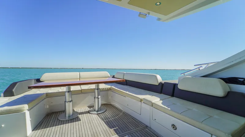 Brigadone Yacht Photos Pics 2016 Azimut 55S yacht deck with seating and table, overlooking calm blue waters.
