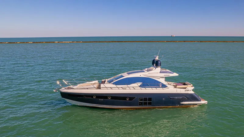 Brigadone Yacht Photos Pics 2016 Azimut 55S yacht cruising on calm blue waters under a clear sky.