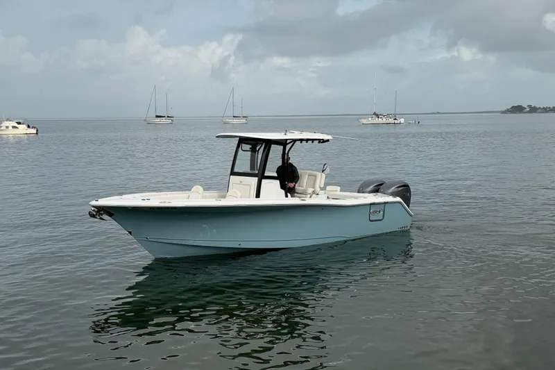  Yacht Photos Pics 2023 Sea Hunt Gamefish 27 boat on calm water with distant sailboats.