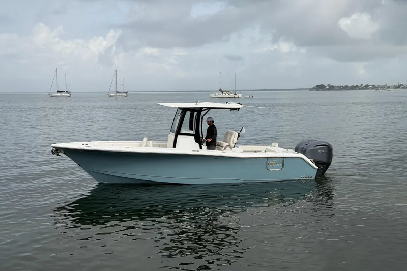  Yacht Photos Pics 2023 Sea Hunt Gamefish 27 boat on calm water with distant sailboats.