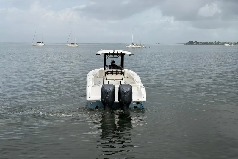  Yacht Photos Pics 2023 Sea Hunt Gamefish 27 boat on calm water with distant sailboats.