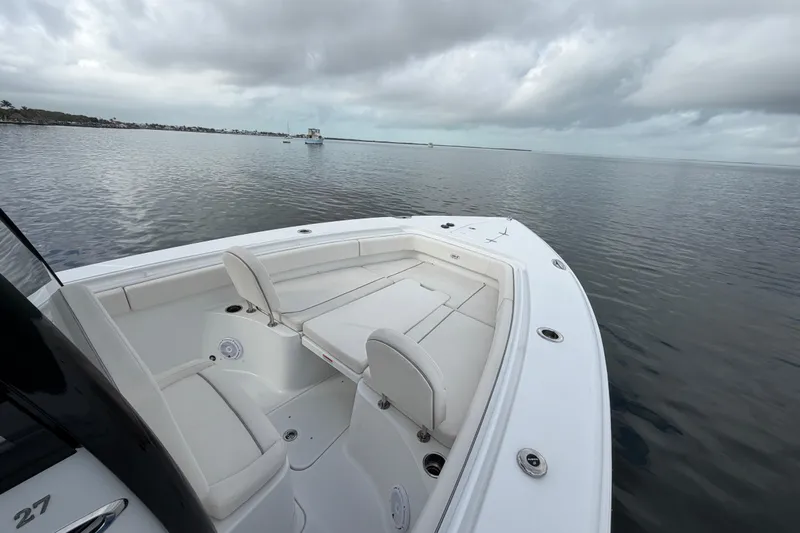  Yacht Photos Pics 2023 Sea Hunt Gamefish 27 Forward Seating boat on calm water under cloudy sky.