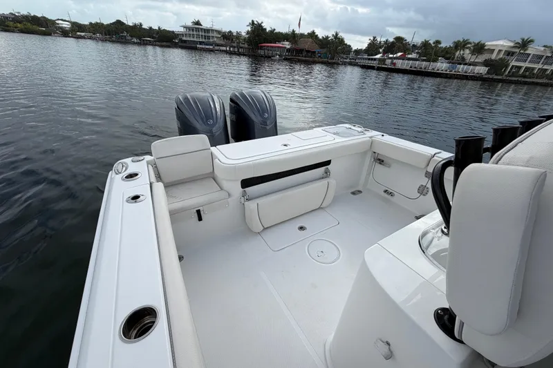  Yacht Photos Pics 2023 Sea Hunt Gamefish 27 boat with forward seating, docked on calm water.
