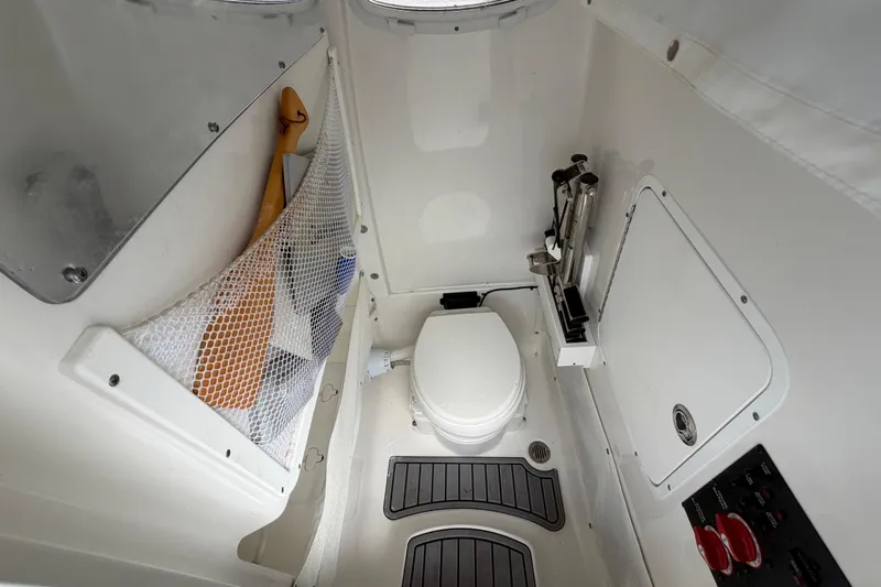  Yacht Photos Pics 2023 Sea Hunt Gamefish 27 boat interior with toilet and storage area.