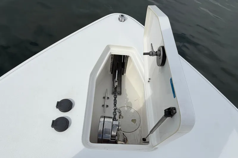  Yacht Photos Pics 2023 Sea Hunt Gamefish 27 anchor compartment with open hatch, showing chain and mechanism.