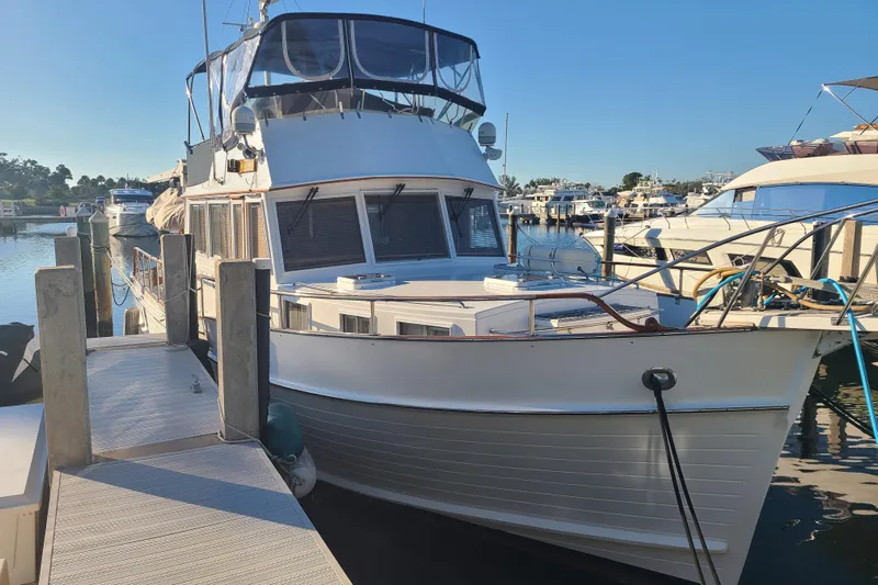 Breakaway Yacht Photos Pics Grand Banks 46 Classic yacht, 2000 model, docked at a marina under clear blue skies.
