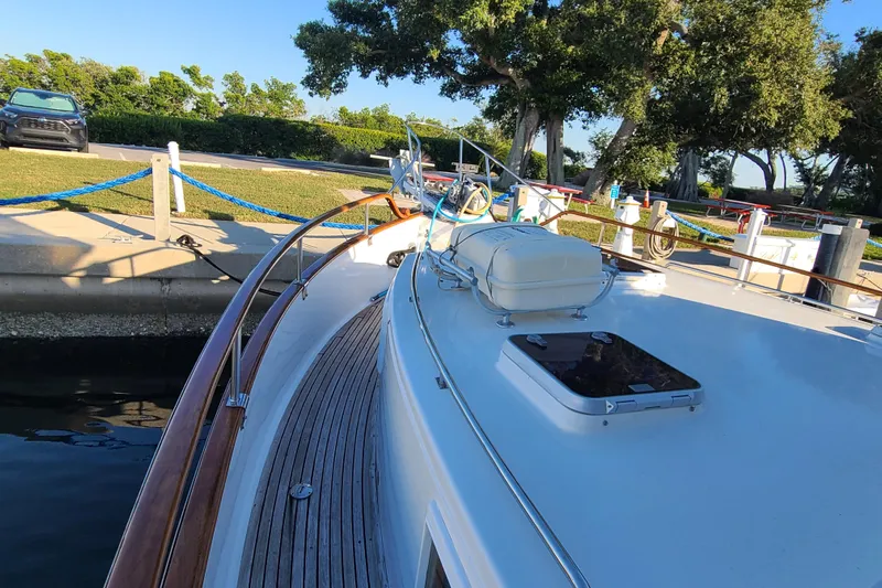 Breakaway Yacht Photos Pics Grand Banks 46 Classic yacht docked, showcasing sleek deck design and polished wood railings.