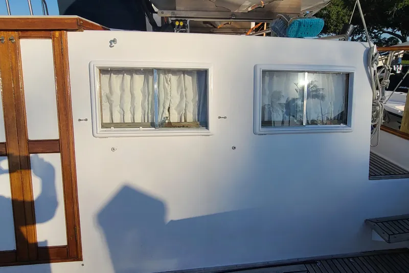 Breakaway Yacht Photos Pics Side view of 2000 Grand Banks 46 Classic yacht with windows and wooden trim.