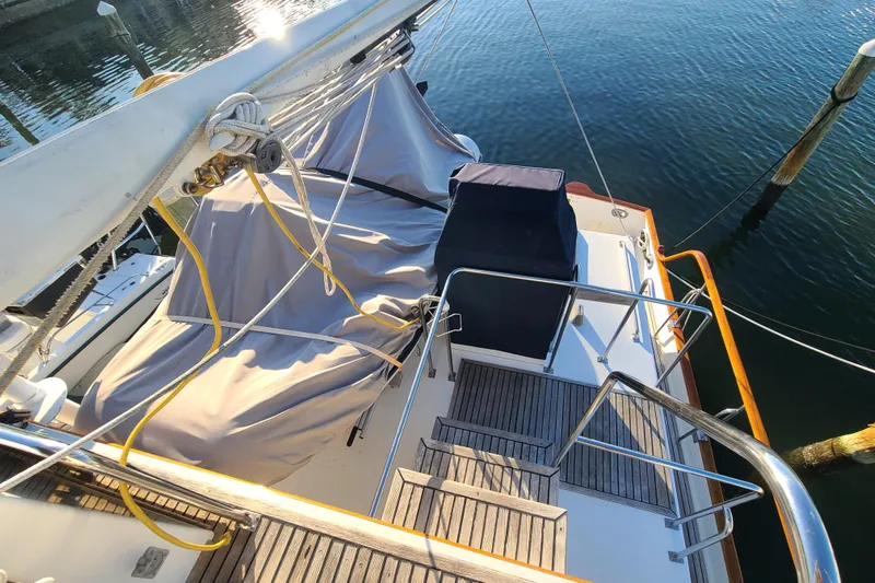 Breakaway Yacht Photos Pics 2000 Grand Banks 46 Classic yacht deck with covered seating, docked on calm water.