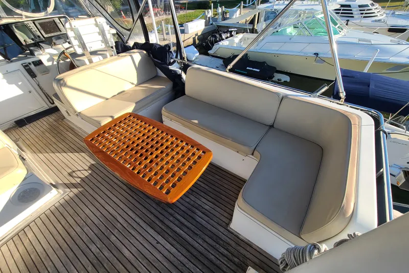 Breakaway Yacht Photos Pics Grand Banks 46 Classic 2000 yacht interior with cushioned seating and wooden table.