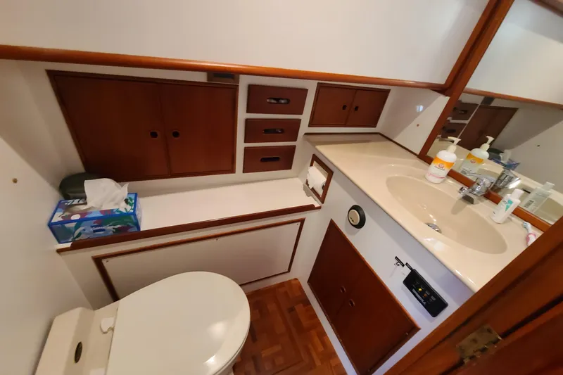 Breakaway Yacht Photos Pics Bathroom interior of 2000 Grand Banks 46 Classic yacht, featuring wooden cabinetry and sink.