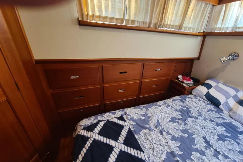 Breakaway Yacht Photos Pics Cozy bedroom interior of 2000 Grand Banks 46 Classic yacht with wooden drawers and floral bedding.