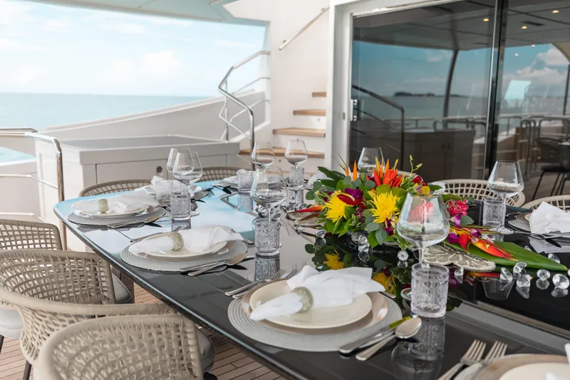 Emina Yacht Photos Pics Elegant dining setup on 2014 Benetti Veloce 140 yacht with ocean view.