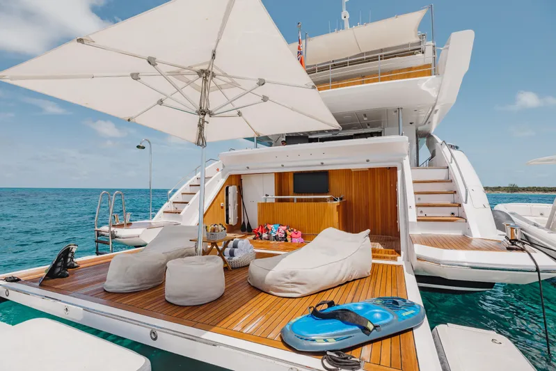 Emina Yacht Photos Pics Luxurious 2014 Benetti Veloce 140 yacht deck with seating, umbrella, and ocean view.