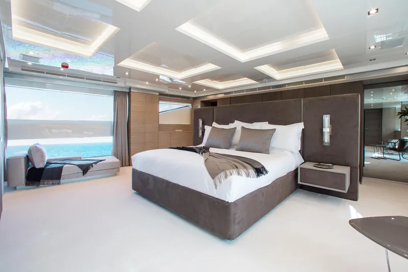 Emina Yacht Photos Pics Luxurious bedroom interior on 2014 Benetti Veloce 140 yacht, featuring ocean view and modern design.