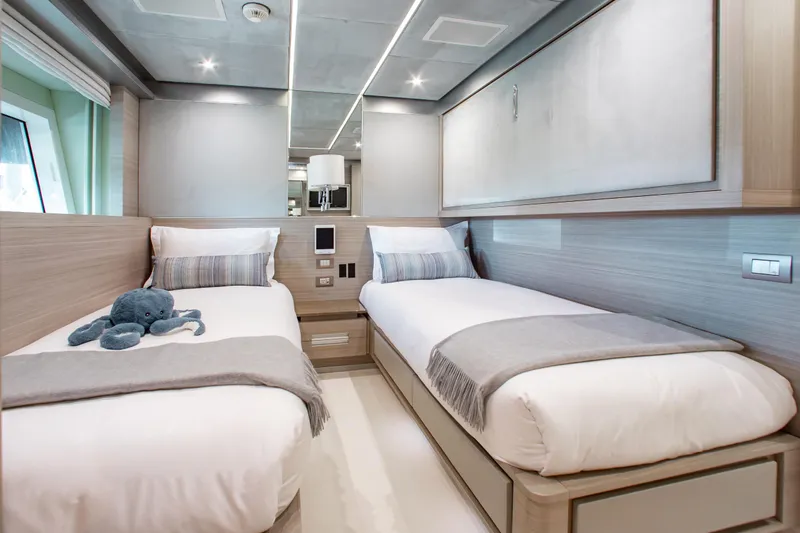 Emina Yacht Photos Pics Luxurious twin cabin on 2014 Benetti Veloce 140 yacht, featuring modern design and plush bedding.