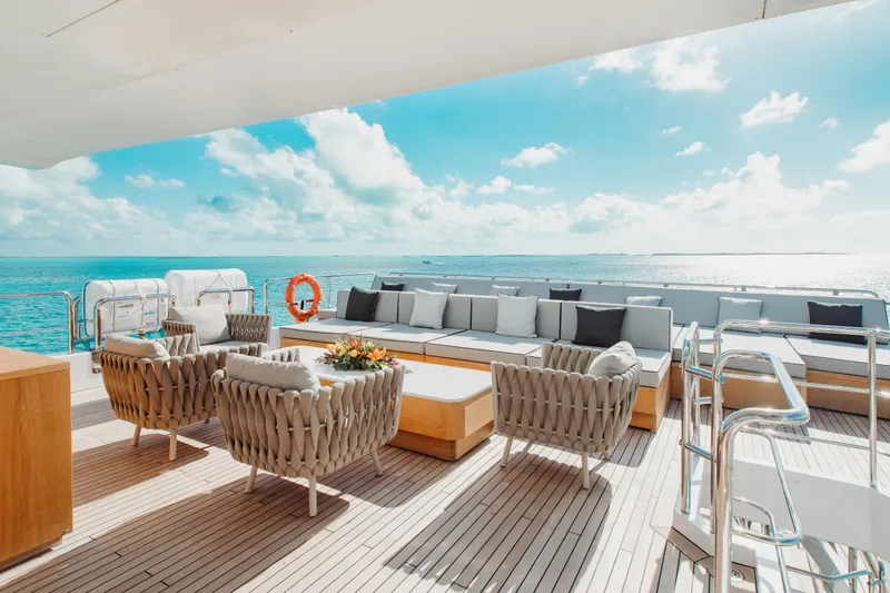 Emina Yacht Photos Pics Luxurious deck of 2014 Benetti Veloce 140 yacht with elegant seating and ocean view.