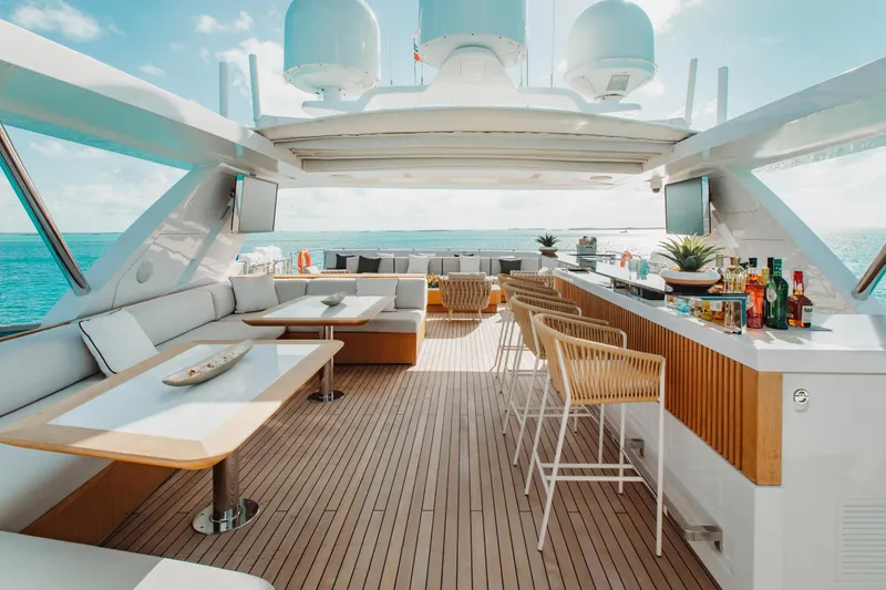 Emina Yacht Photos Pics Luxurious 2014 Benetti Veloce 140 yacht deck with bar, seating, and ocean view.