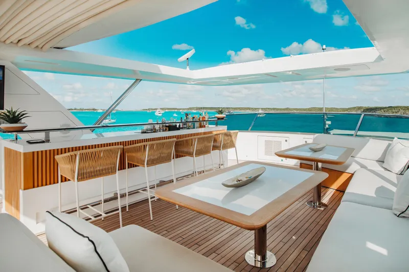 Emina Yacht Photos Pics Luxurious 2014 Benetti Veloce 140 yacht deck with bar, seating, and ocean view.