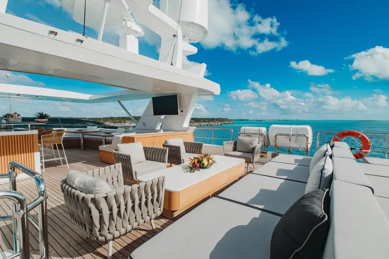 Emina Yacht Photos Pics Luxurious 2014 Benetti Veloce 140 yacht deck with elegant seating and ocean view.