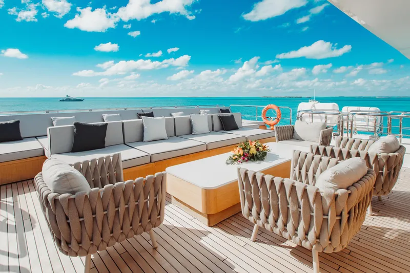 Emina Yacht Photos Pics Luxurious deck of 2014 Benetti Veloce 140 yacht with elegant seating and ocean view.