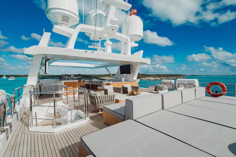Emina Yacht Photos Pics Luxurious 2014 Benetti Veloce 140 yacht deck with seating, ocean view, and clear blue sky.